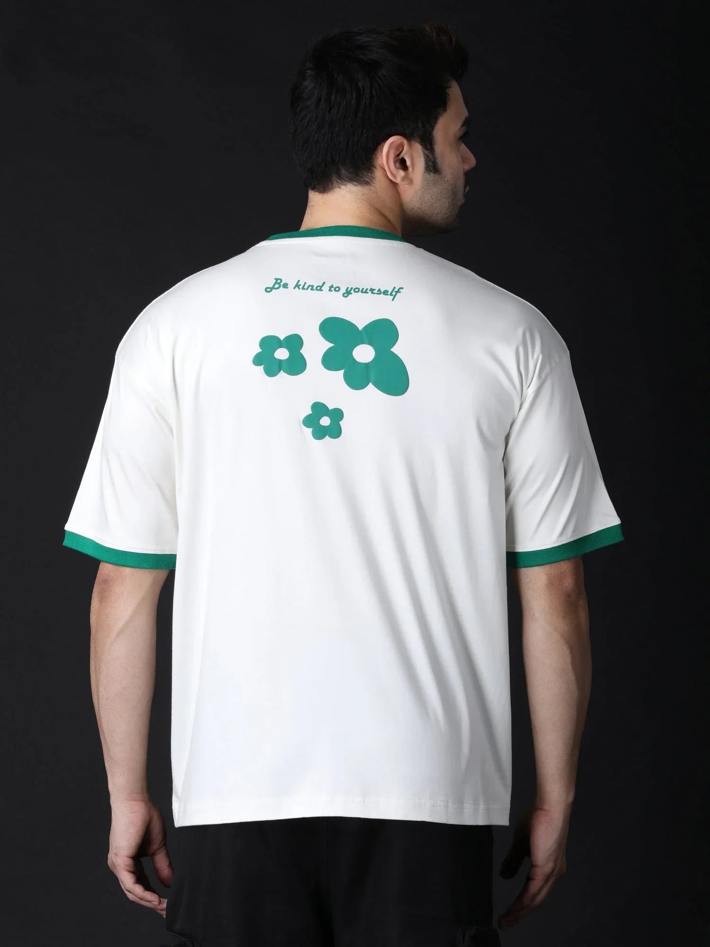 Cream oversized flower t-shirt featuring green flower graphics on the back for a trendy look