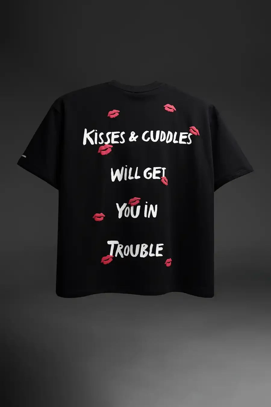 Black t-shirt with white text and red lip prints on a dark background