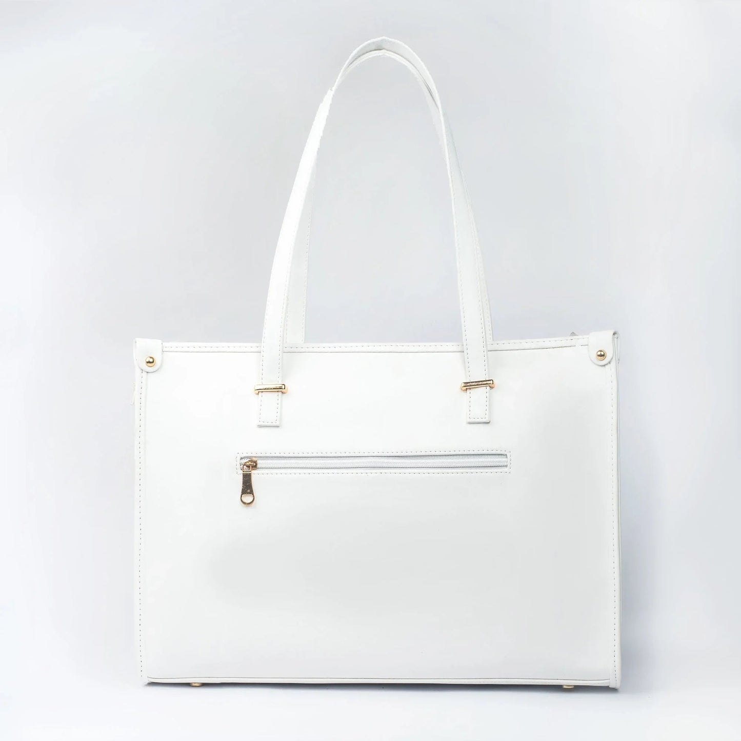 Large designer tote bag in white with gold accents and a zippered pocket for added convenience