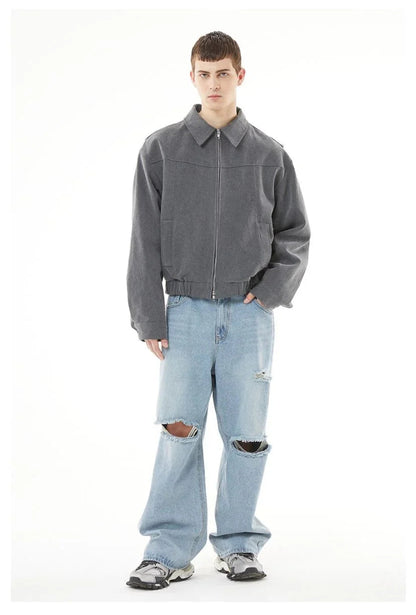 Close up of distressed ripped details on men's slash cut baggy denim.