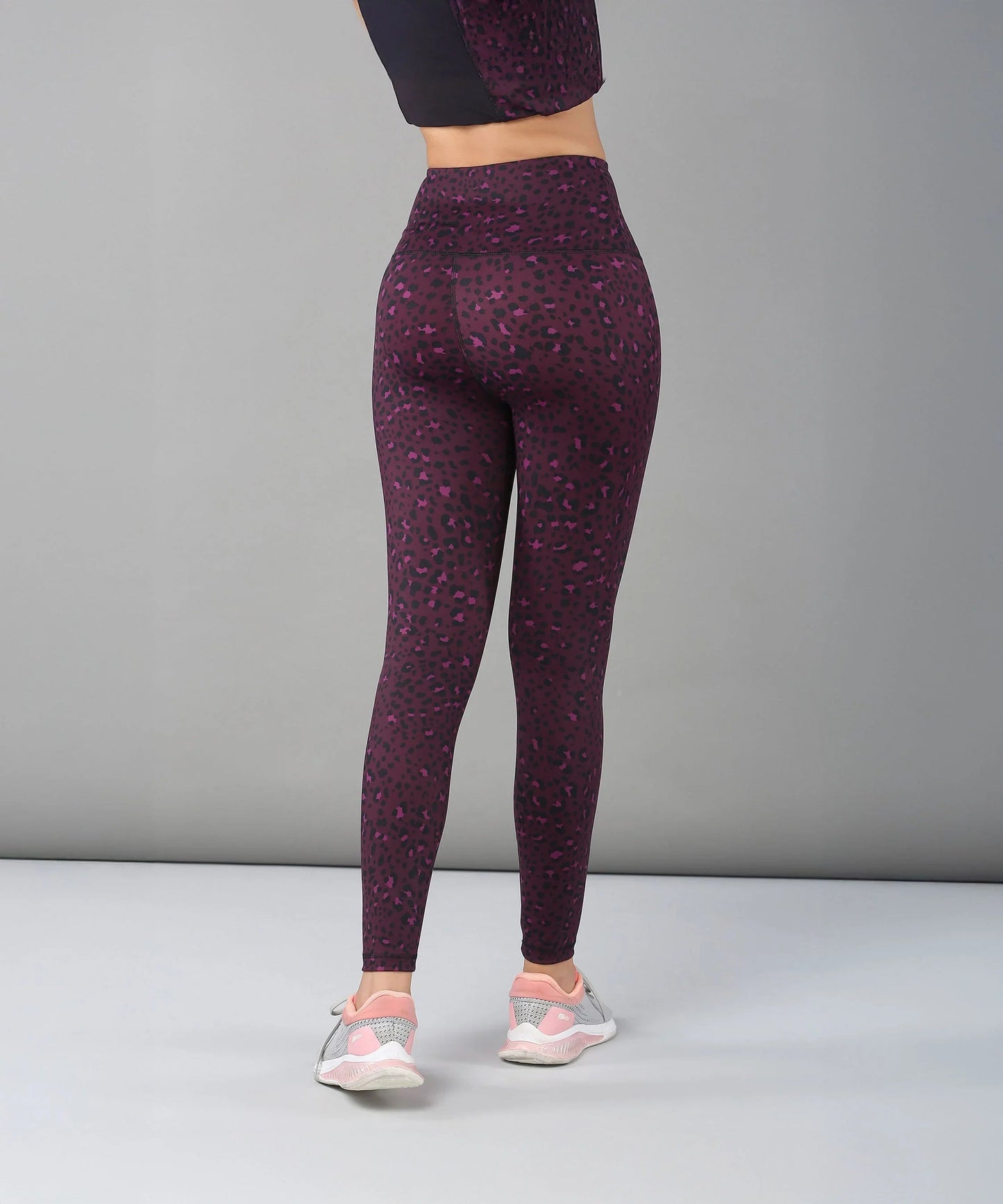 Stylish purple and black leggings for women, perfect for workouts and casual wear, featuring a high waistband