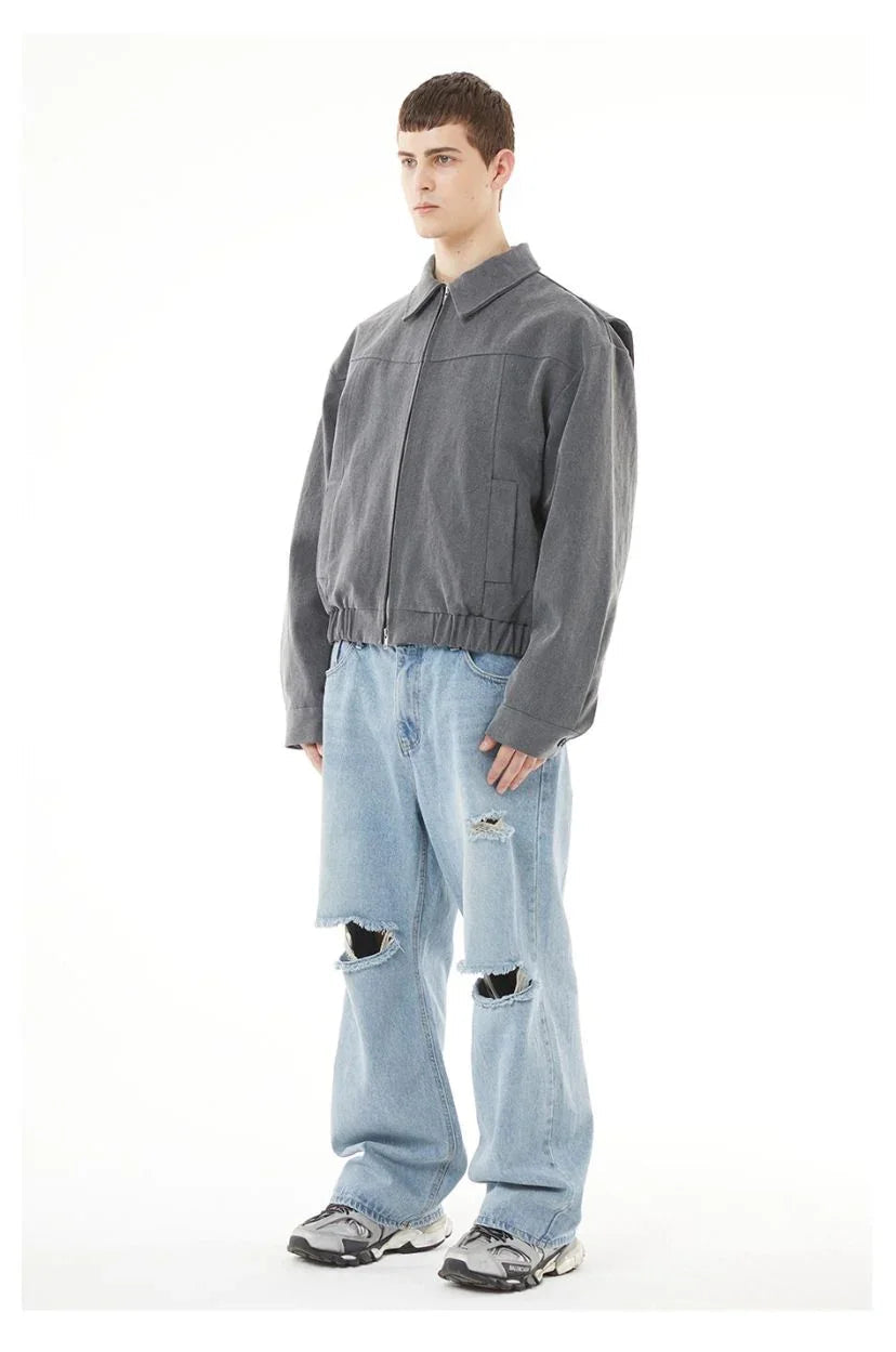 Back view of light blue ripped jeans men styling with a casual streetwear aesthetic.
