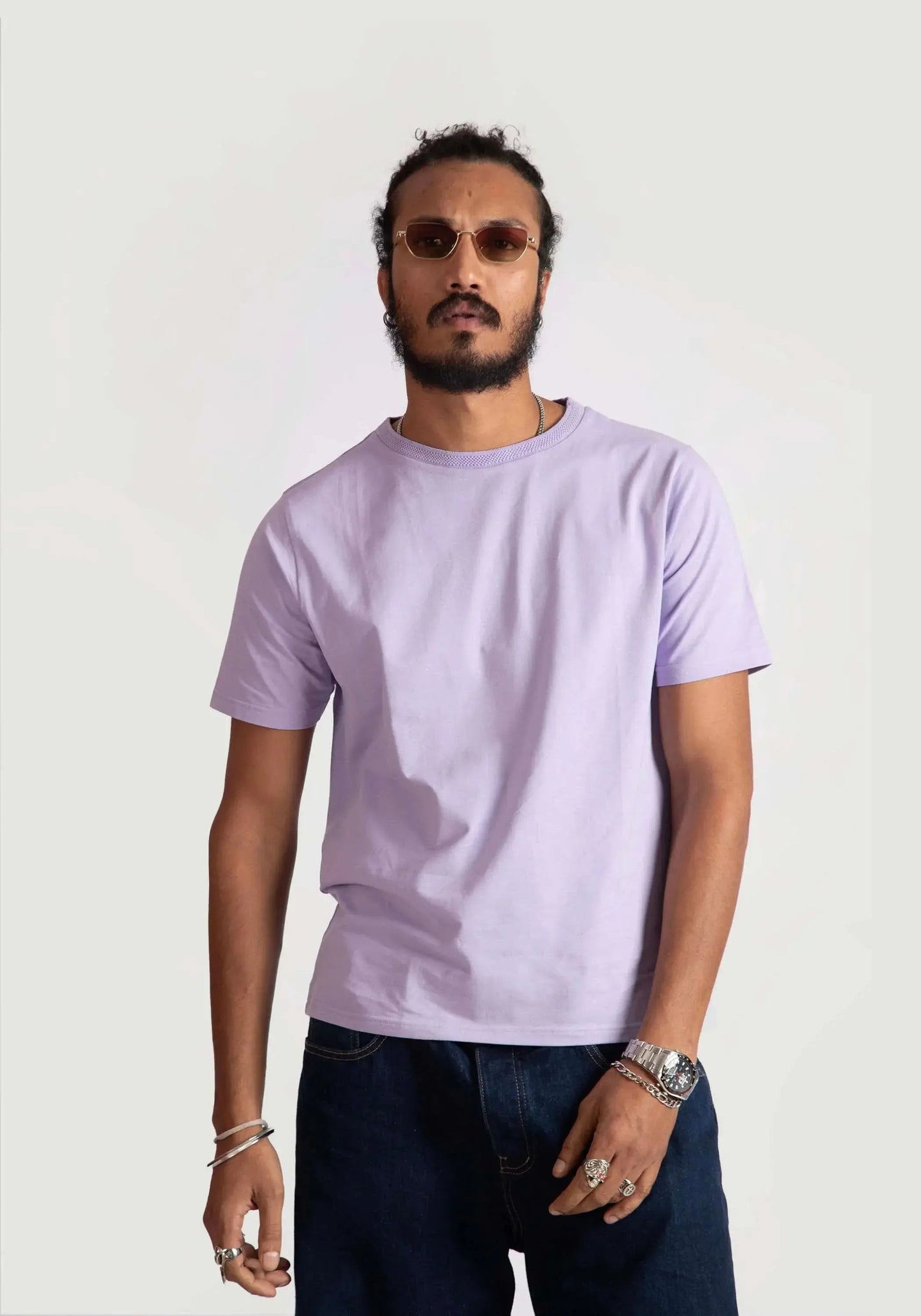 Man wearing Stylera men's regular fit lavender tee paired with dark jeans and sunglasses