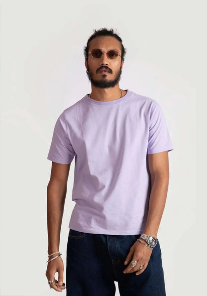 Man wearing Stylera men's regular fit lavender tee paired with dark jeans and sunglasses