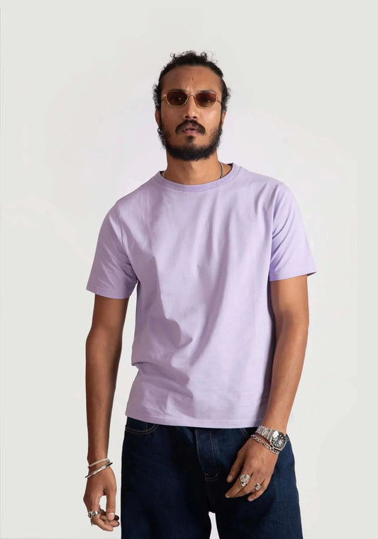 Man wearing Stylera men's regular fit lavender tee paired with dark jeans and sunglasses