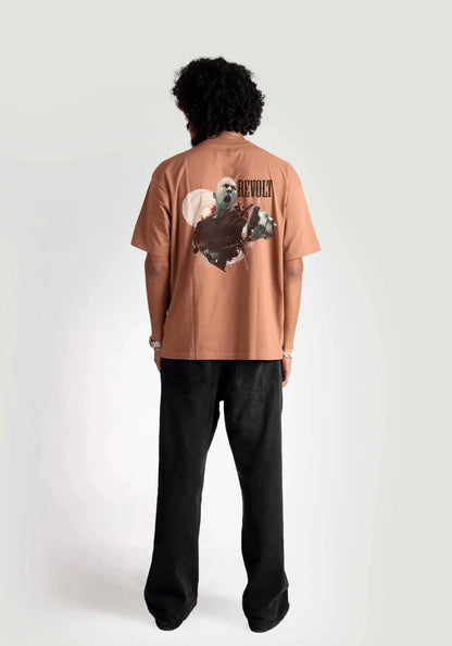 Back view of model wearing Stylera mocha oversized t-shirt with graphic design and black pants