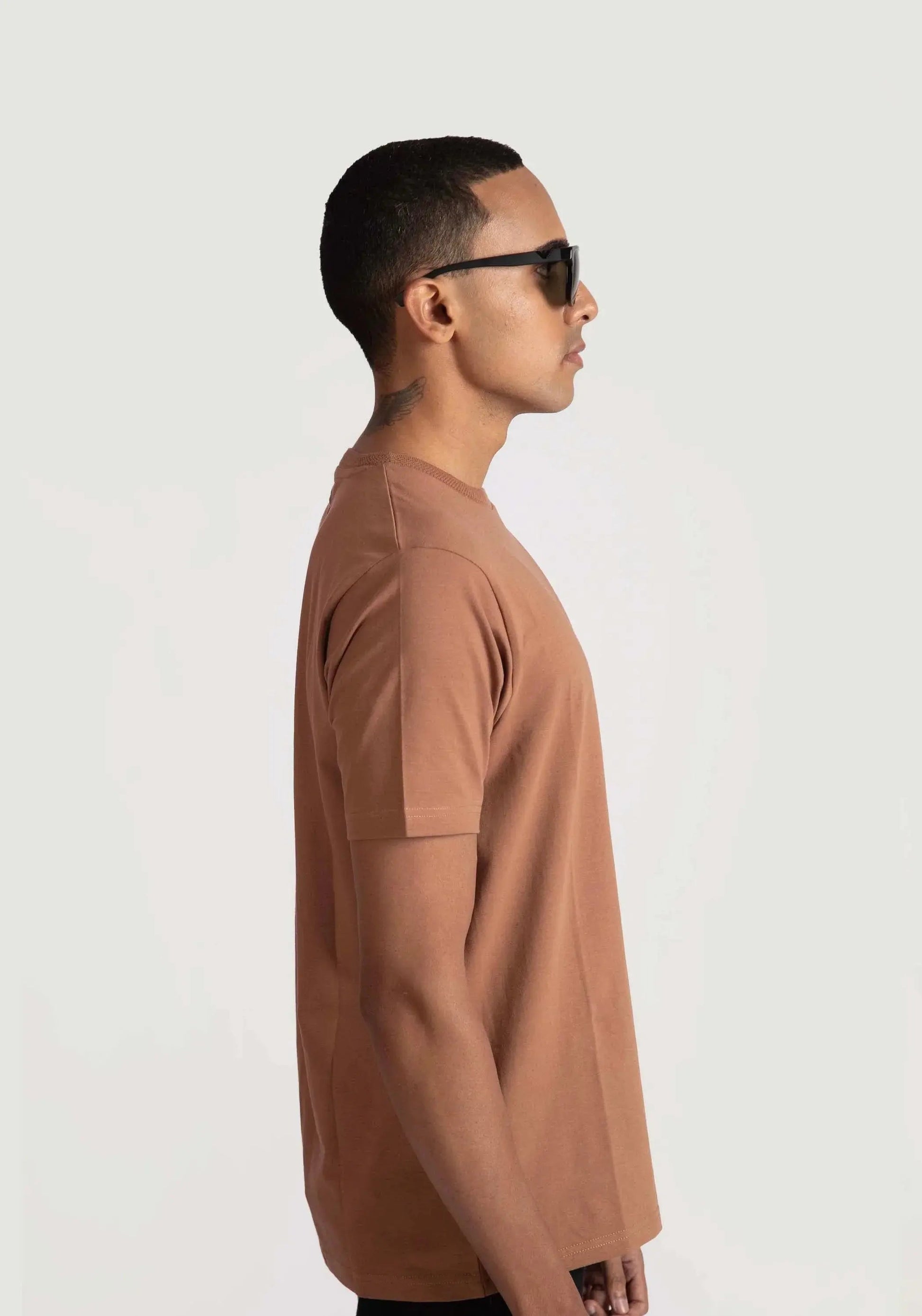 Stylera brown regular fit casual tee worn by a man in profile view with sunglasses