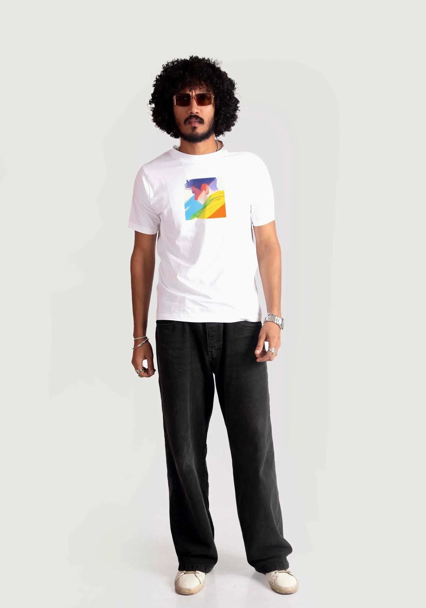 Man wearing Stylera regular fit white tee with colorful graphic and black pants
