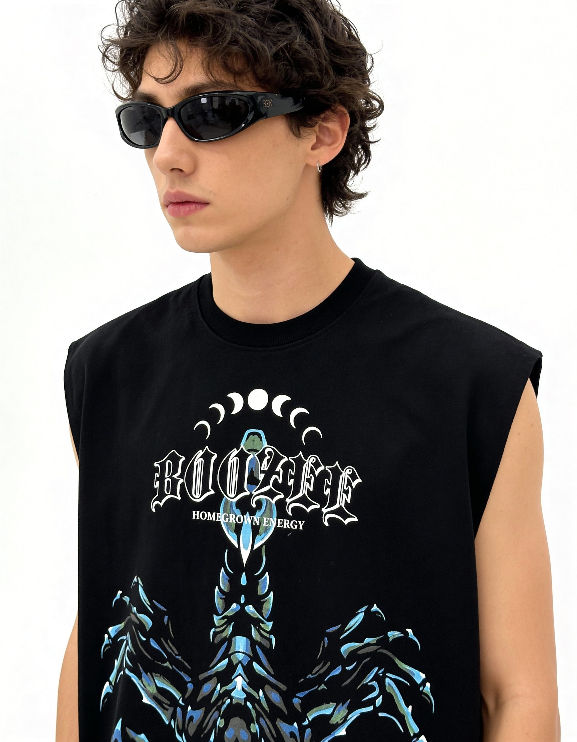 Person wearing a black sleeveless shirt with a graphic design and text.