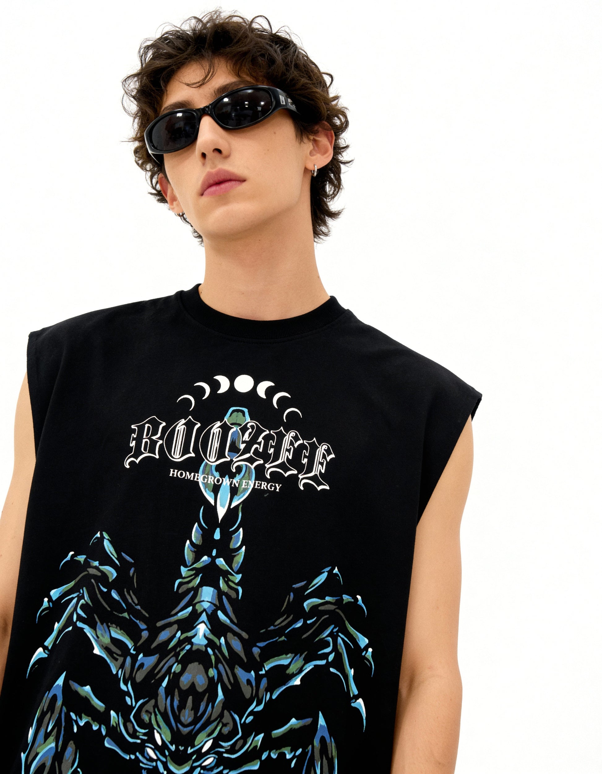 Person wearing a black sleeveless shirt with a graphic design and text.