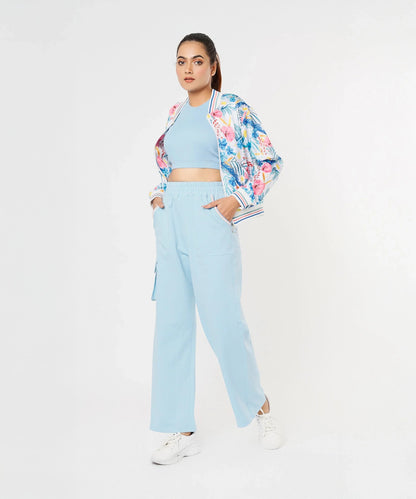 Trendy model wearing stylish co ord sets for women, featuring a floral bomber jacket and light blue pants
