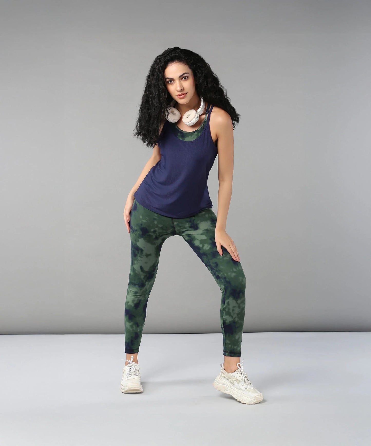 Model wearing a navy top and green tie dye bra t shirt for stylish activewear looks