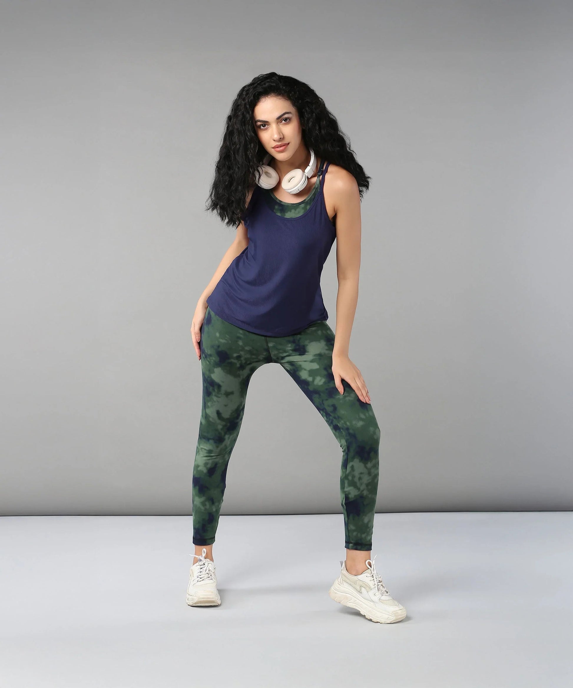 Model wearing a navy top and green tie dye bra t shirt for stylish activewear looks