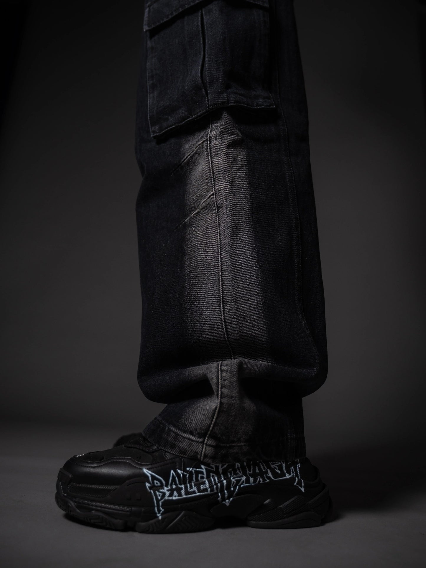 Model posing in wide leg tough jeans streetwear outfit with chunky boots.