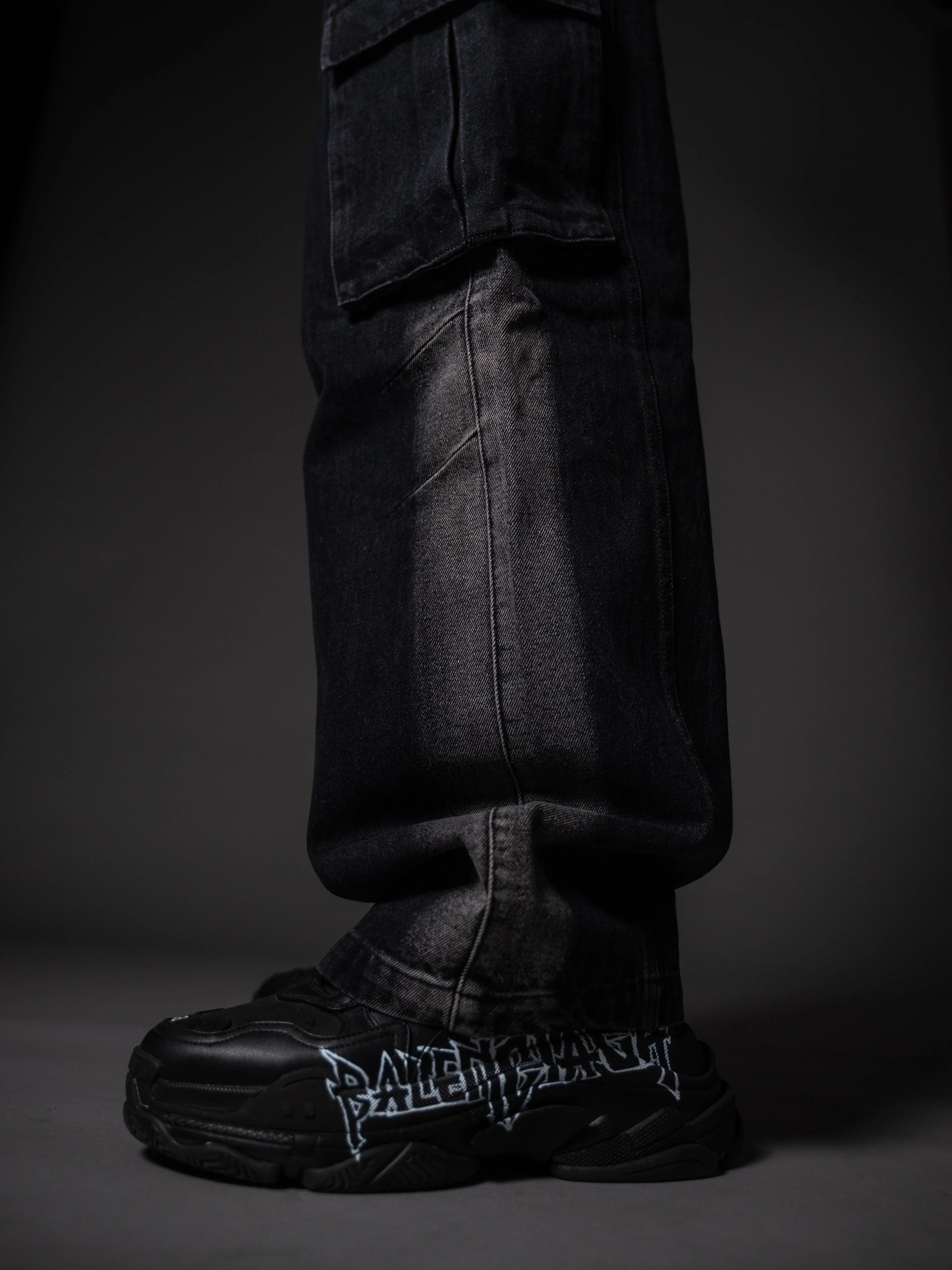 Model posing in wide leg tough jeans streetwear outfit with chunky boots.