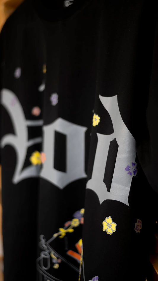 Stylstpls trendy streetwear black t-shirt featuring colorful floral designs and a bold graphic print
