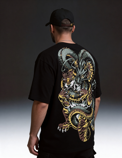 Person wearing a black t-shirt with a colorful dragon design on the back against a dark background