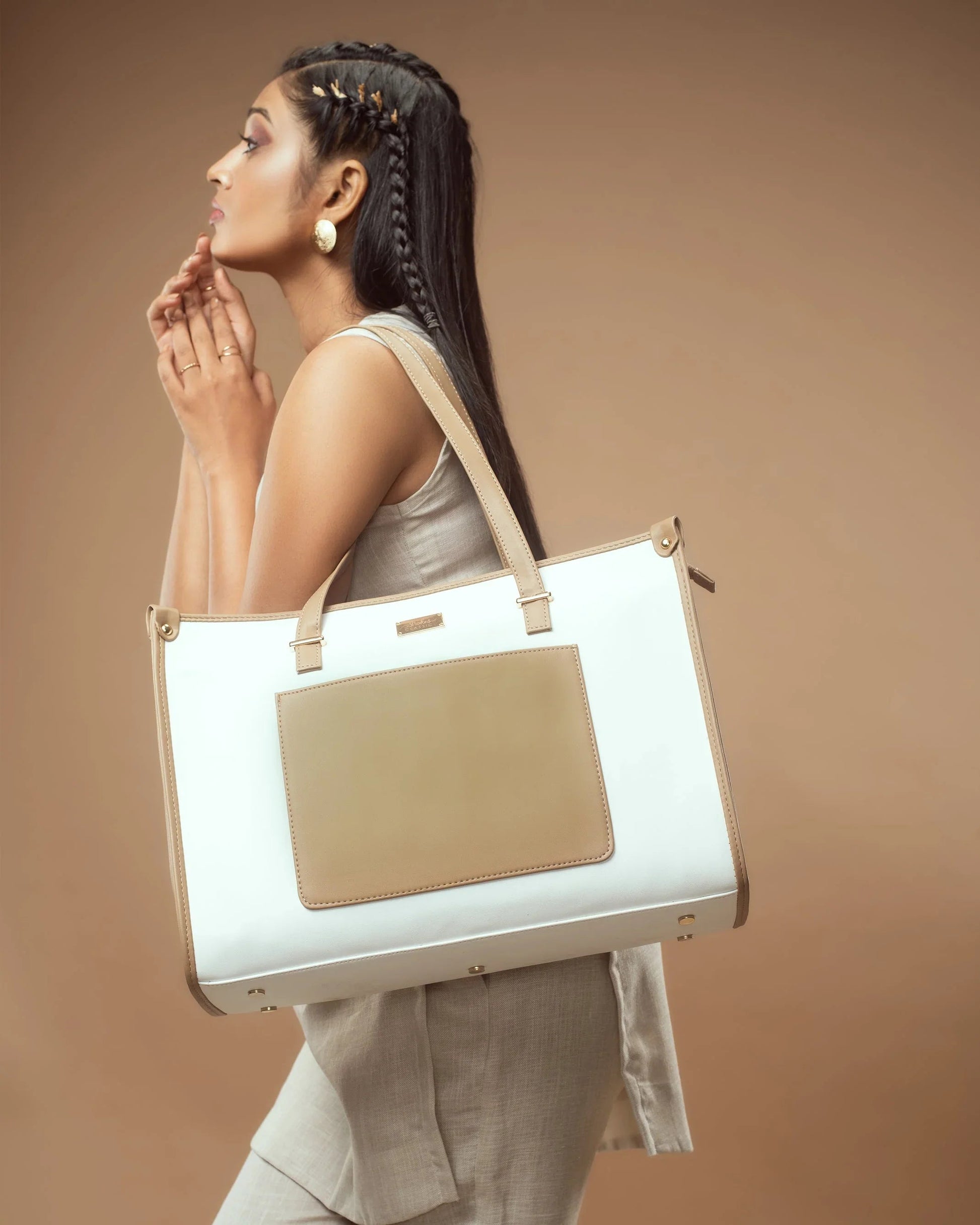 Woman carrying a vanilla taupe box tote bag with elegant design and spacious interior