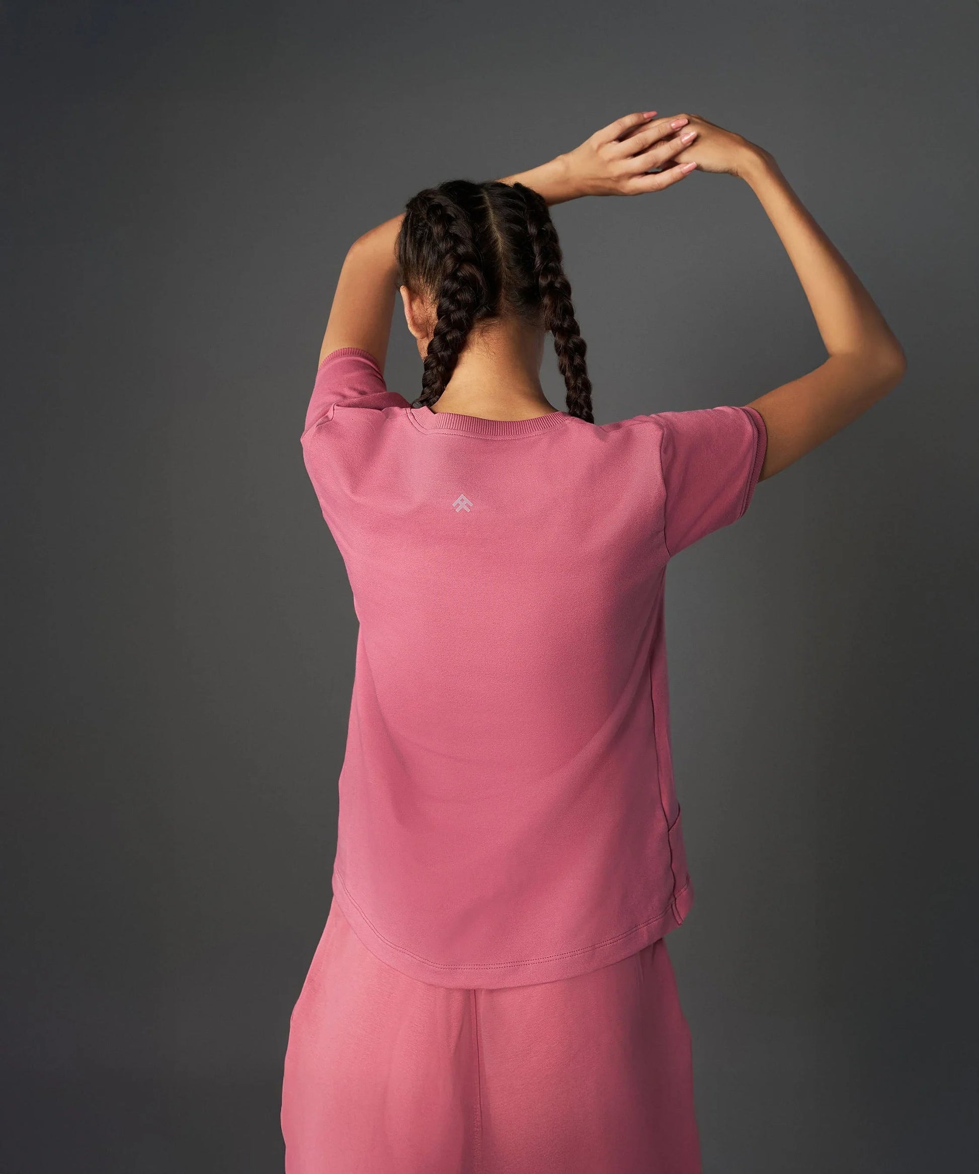 Back view of a model wearing a vintage pink co-ord set with a relaxed fit and breathable fabric