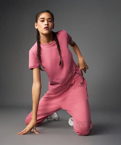 Stylish model showcasing a vintage pink co-ord set featuring a relaxed t-shirt and matching pants