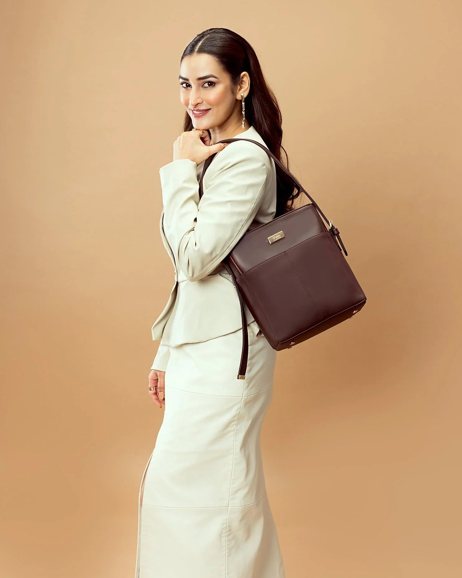 Stylish Stylera women's leather shoulder bag showcased on a model in a chic outfit